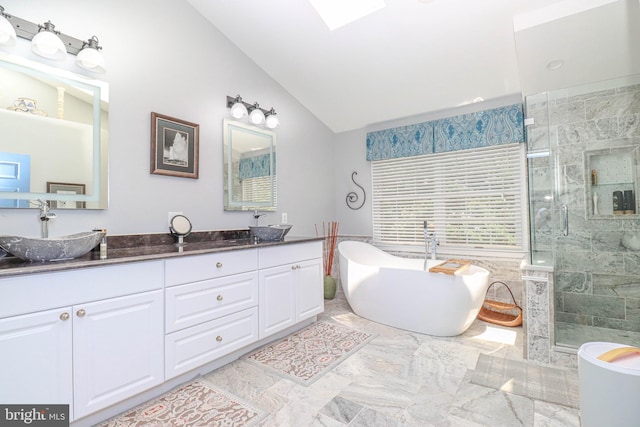 full bath with double vanity, lofted ceiling, a freestanding bath, a shower stall, and a sink