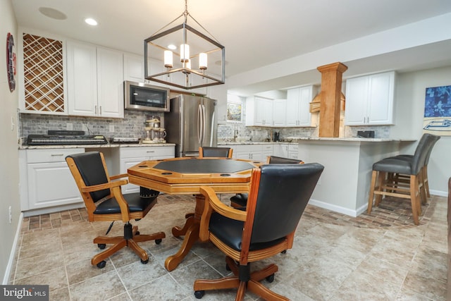 dining space featuring baseboards and recessed lighting