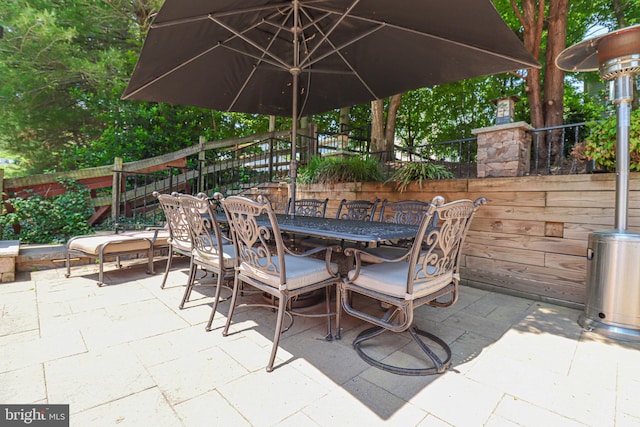 view of patio featuring outdoor dining area and fence