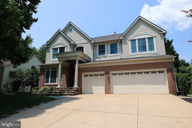 view of front of house with driveway, brick siding, and an attached garage