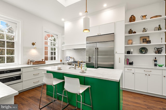 kitchen with white cabinetry, open shelves, tasteful backsplash, and appliances with stainless steel finishes
