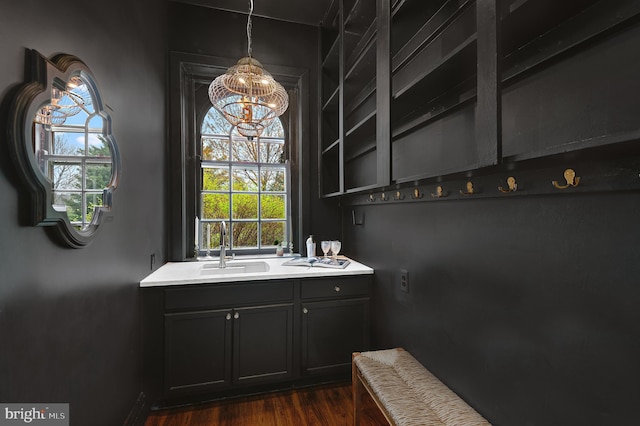 bathroom featuring a sink, a chandelier, and wood finished floors
