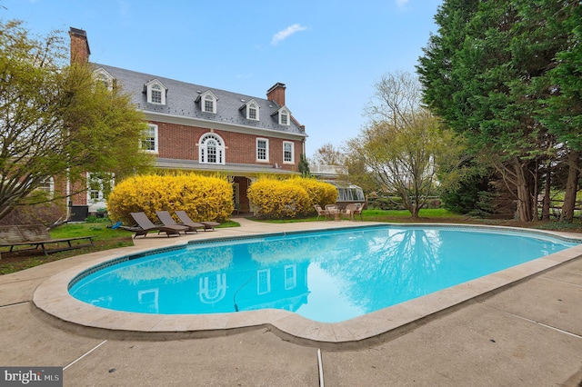 outdoor pool featuring a patio area