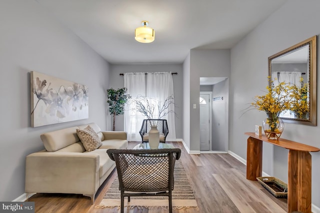 living area with wood finished floors and baseboards