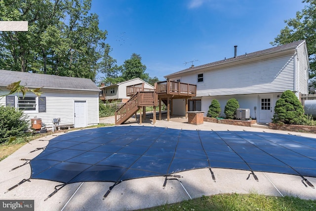 view of pool featuring a patio, central air condition unit, stairway, a deck, and a covered pool