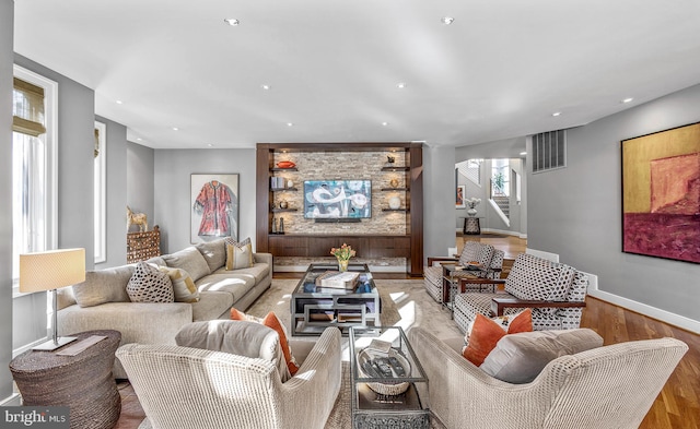 living room with recessed lighting, wood finished floors, visible vents, baseboards, and stairway