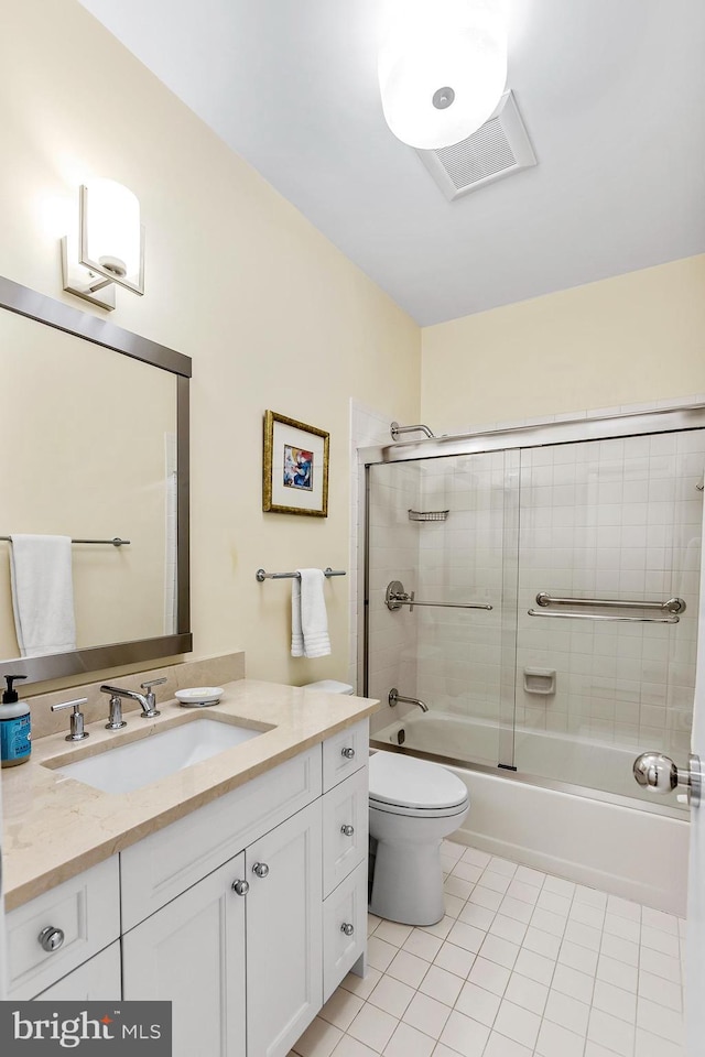 bathroom with toilet, vanity, bath / shower combo with glass door, and tile patterned floors