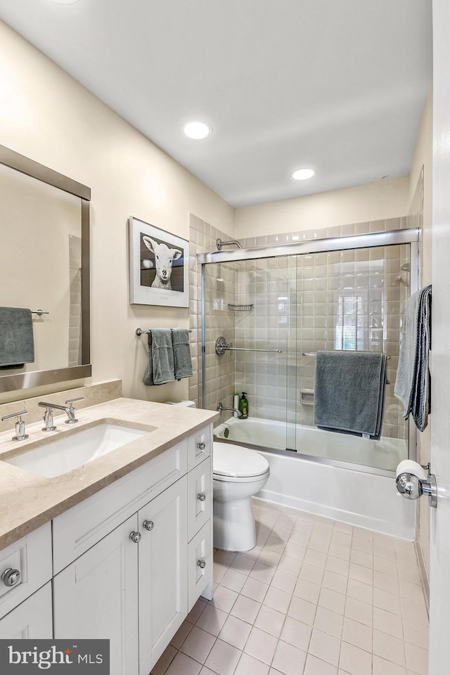 bathroom featuring enclosed tub / shower combo, tile patterned flooring, toilet, recessed lighting, and vanity