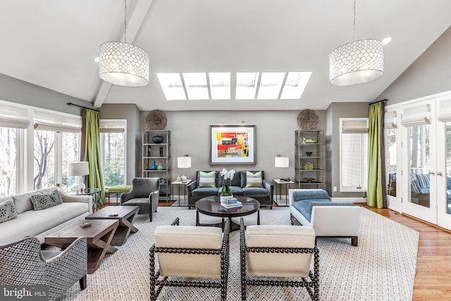 living area with high vaulted ceiling, french doors, wood finished floors, and beamed ceiling