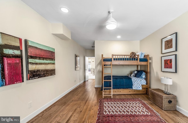 bedroom featuring recessed lighting, wood finished floors, and baseboards