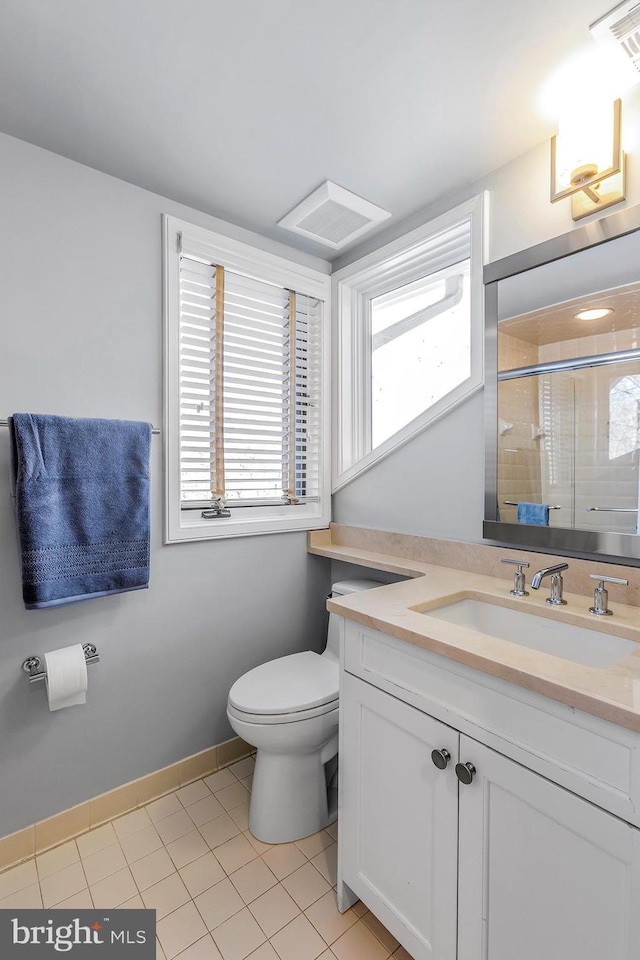 full bathroom featuring a stall shower, plenty of natural light, vanity, and toilet