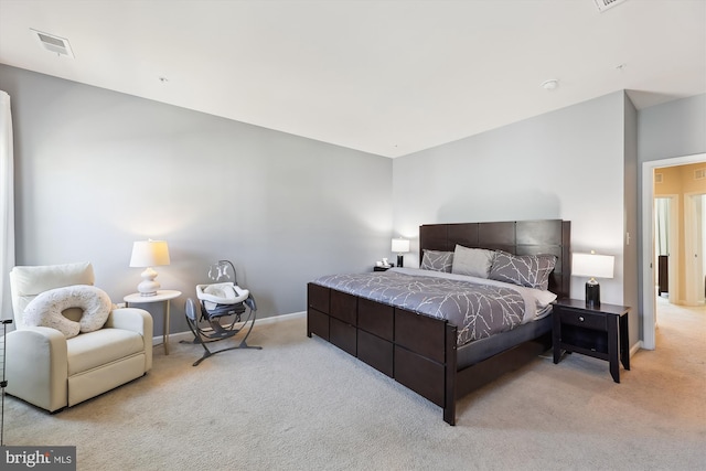 carpeted bedroom featuring visible vents and baseboards