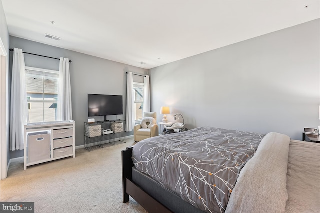 carpeted bedroom featuring visible vents and baseboards