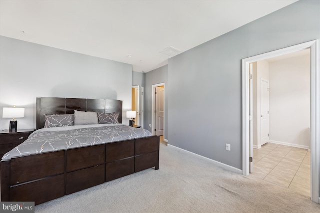 bedroom with light carpet, visible vents, and baseboards