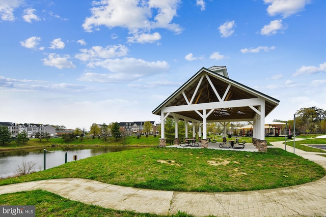 view of property's community featuring a gazebo, a lawn, and a water view