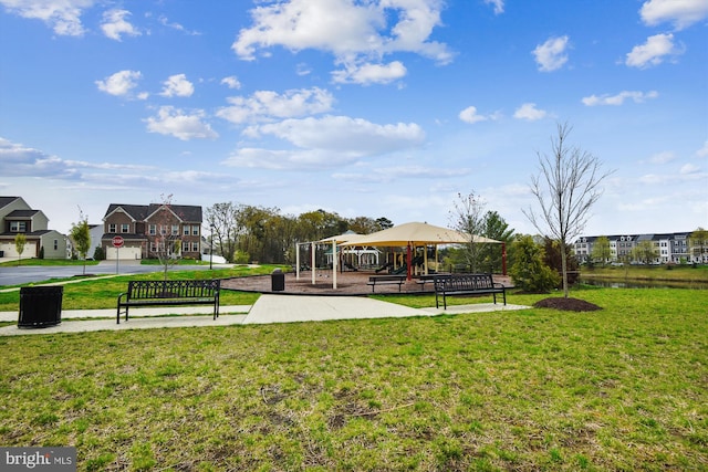 view of property's community with playground community and a yard