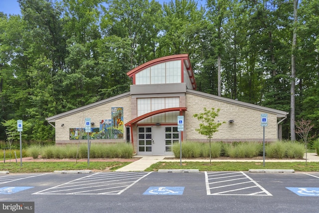 view of building exterior featuring uncovered parking