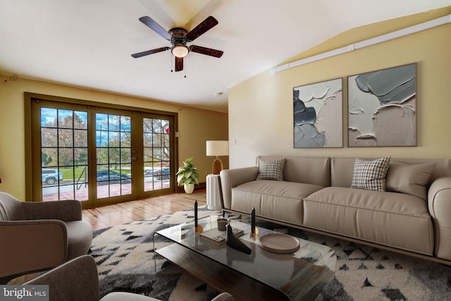 living area featuring vaulted ceiling, french doors, wood finished floors, and a ceiling fan