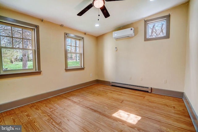 empty room with baseboard heating, ceiling fan, light wood-type flooring, a wall mounted air conditioner, and baseboards