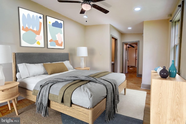 bedroom with wood finished floors and recessed lighting