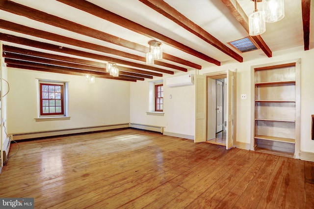 interior space with a wall unit AC, hardwood / wood-style flooring, and beam ceiling