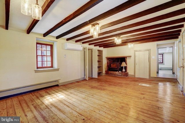 unfurnished living room with a baseboard radiator, a wall unit AC, beamed ceiling, and hardwood / wood-style flooring