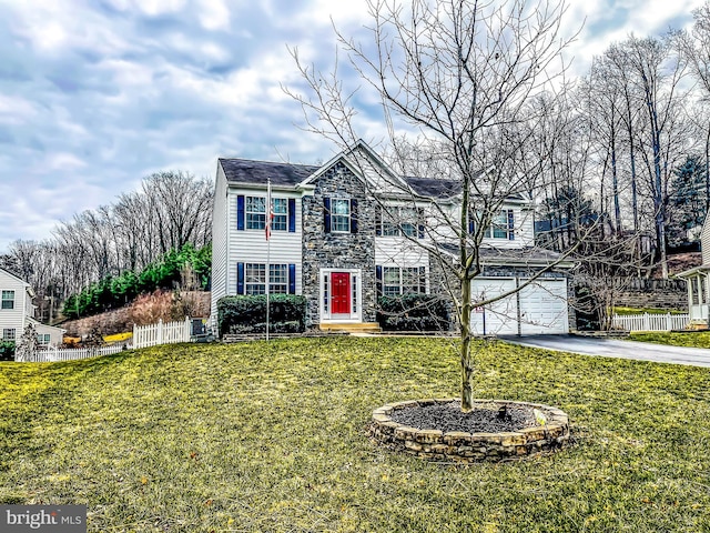 view of front of property with stone siding, aphalt driveway, a front lawn, and fence