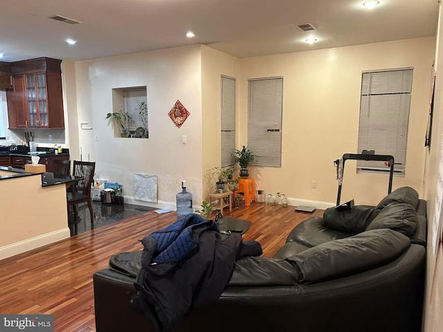 living room with wood finished floors, visible vents, and recessed lighting