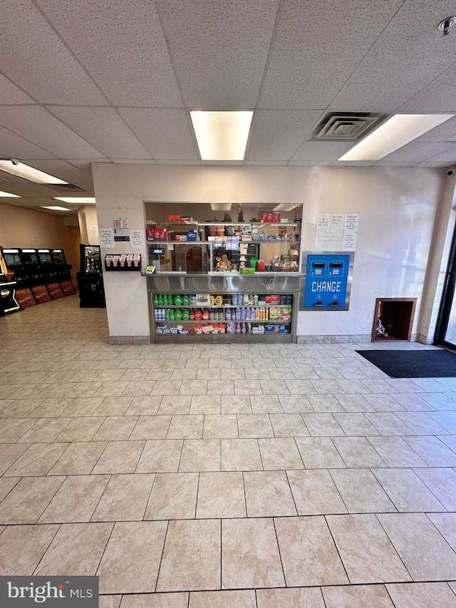 interior space with visible vents and a drop ceiling