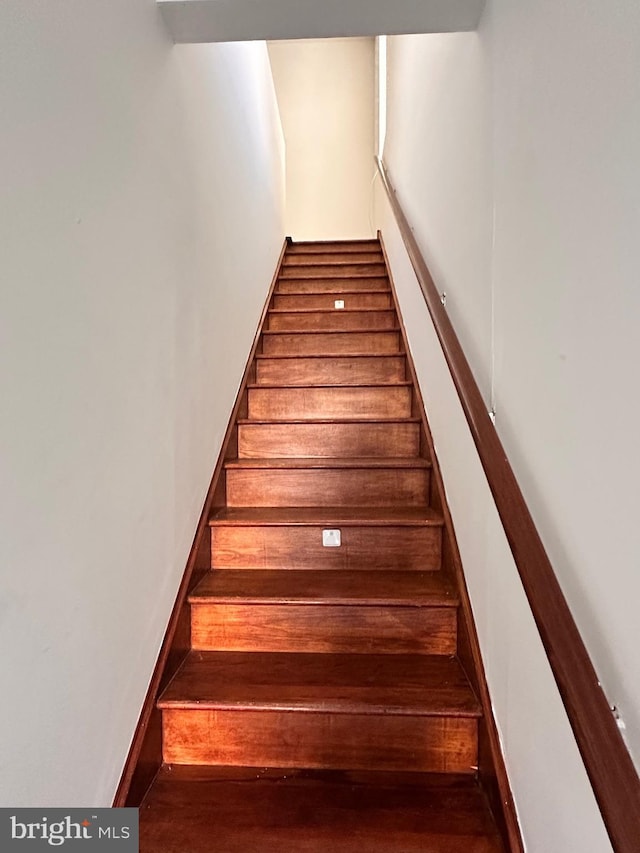 stairs featuring baseboards and wood finished floors