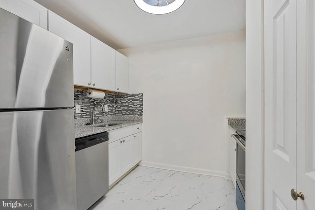 kitchen featuring decorative backsplash, stainless steel appliances, marble finish floor, white cabinetry, and a sink