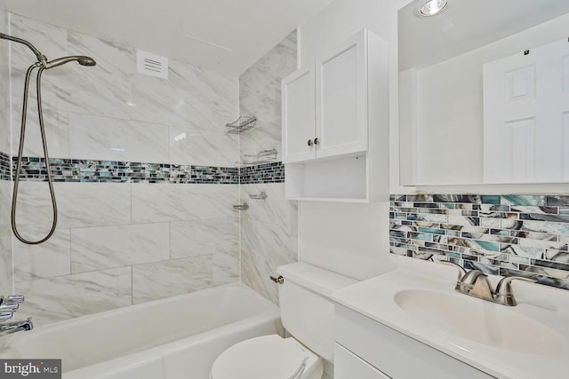 bathroom featuring vanity, visible vents,  shower combination, toilet, and tasteful backsplash