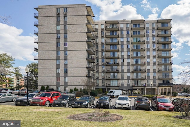 view of building exterior with uncovered parking