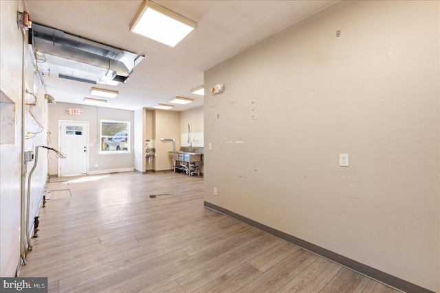 interior space with light wood-type flooring and baseboards