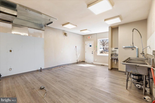 interior space with baseboards and wood finished floors