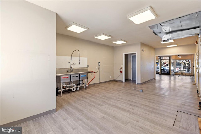 interior space featuring wood finished floors and baseboards