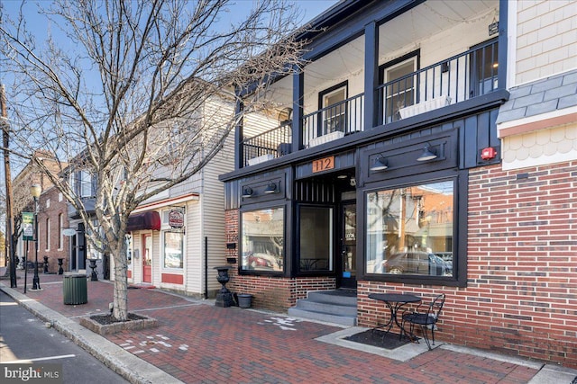 view of exterior entry featuring brick siding