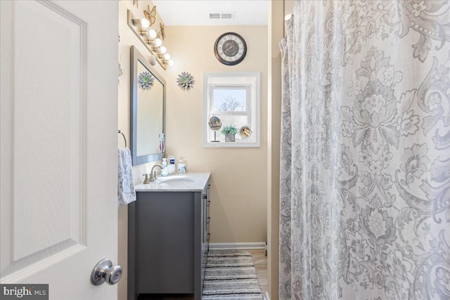 bathroom with a shower with curtain, baseboards, visible vents, and vanity