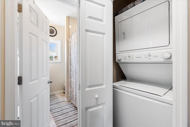 clothes washing area featuring laundry area and stacked washer / drying machine