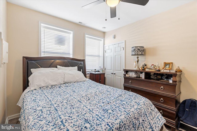 bedroom featuring ceiling fan, a closet, and visible vents