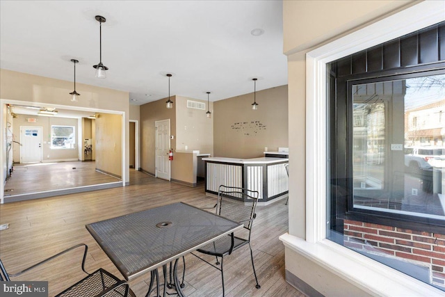 interior space with visible vents, baseboards, and wood finished floors