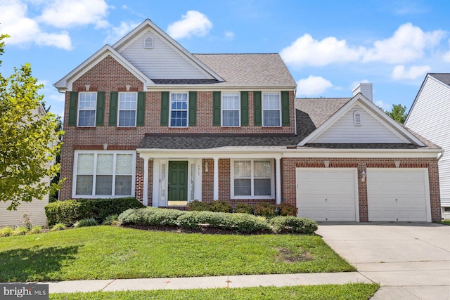 view of front of house featuring a garage, concrete driveway, a front lawn, and brick siding