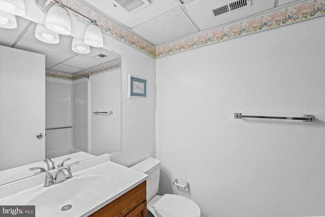 bathroom featuring visible vents, vanity, toilet, and walk in shower