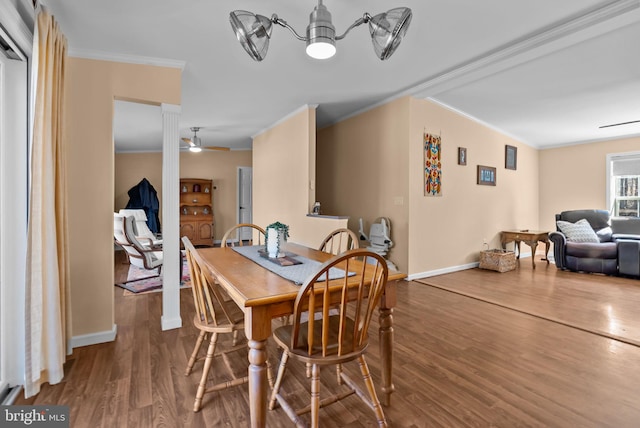 dining area featuring baseboards, ornamental molding, ceiling fan, and wood finished floors