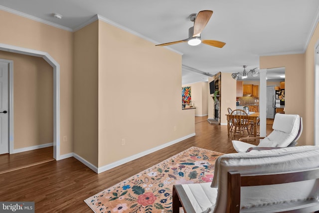 living room with ornamental molding and wood finished floors