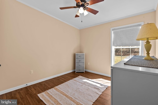 interior space featuring a ceiling fan, baseboards, wood finished floors, and ornamental molding