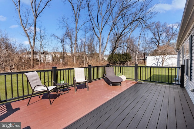 wooden terrace featuring a lawn