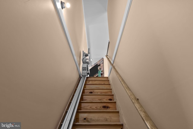 staircase featuring a high ceiling