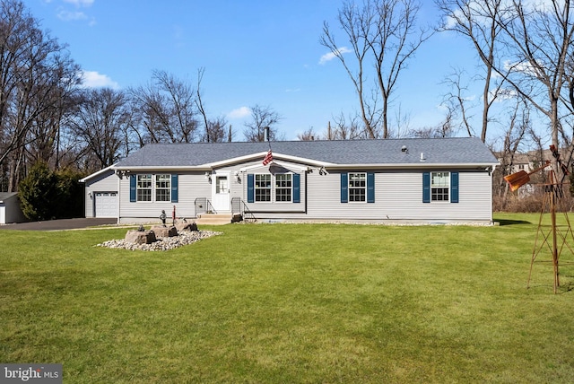 view of front facade with a garage, aphalt driveway, and a front lawn