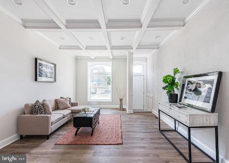 living area with coffered ceiling, beamed ceiling, baseboards, and wood finished floors